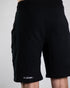 Kurze Raver Hose in schwarz mit "Natzen" Silberreflex Aufdruck am Hosenbein, von hinten fotografiert